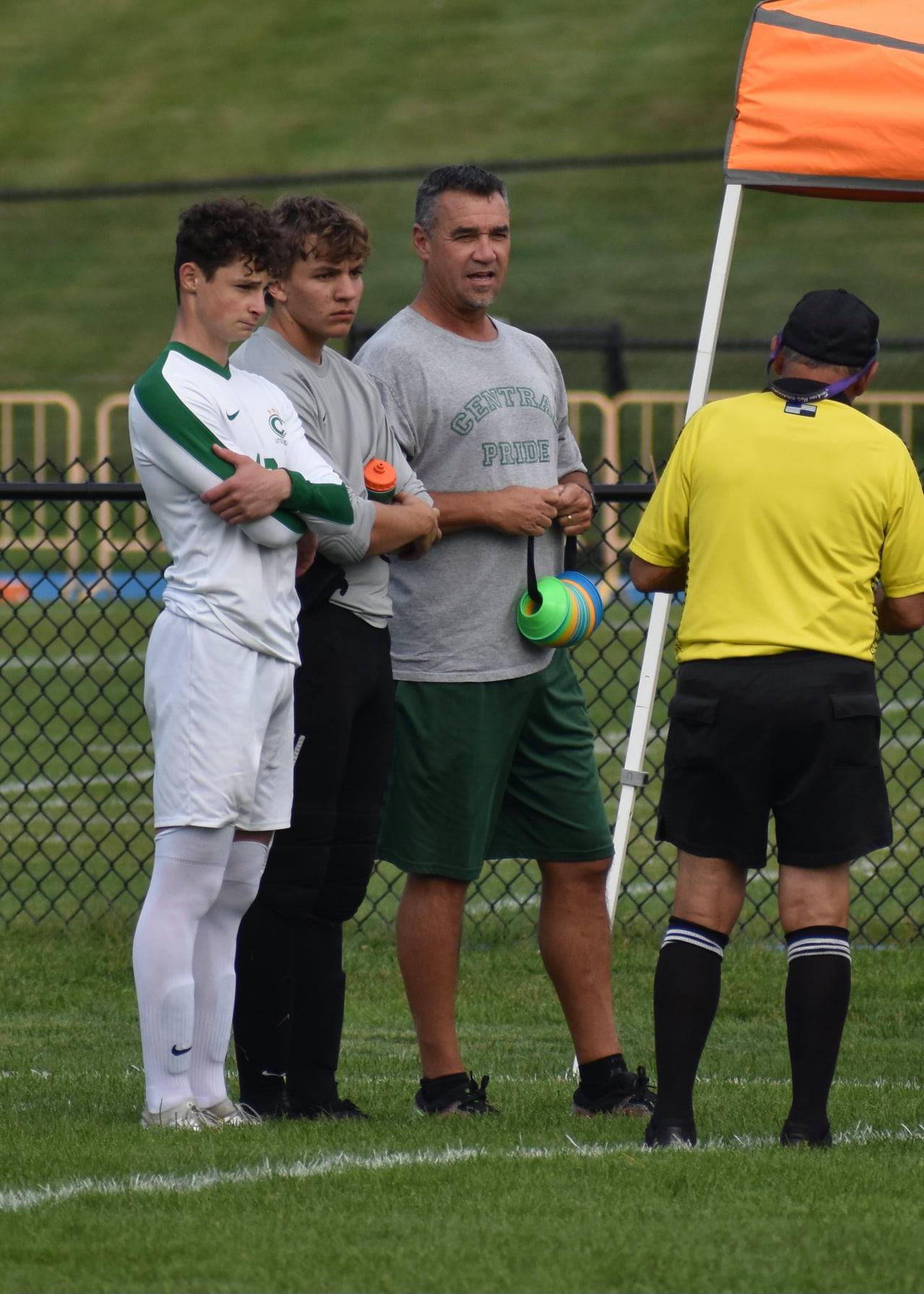 Central coach and players on the sideline