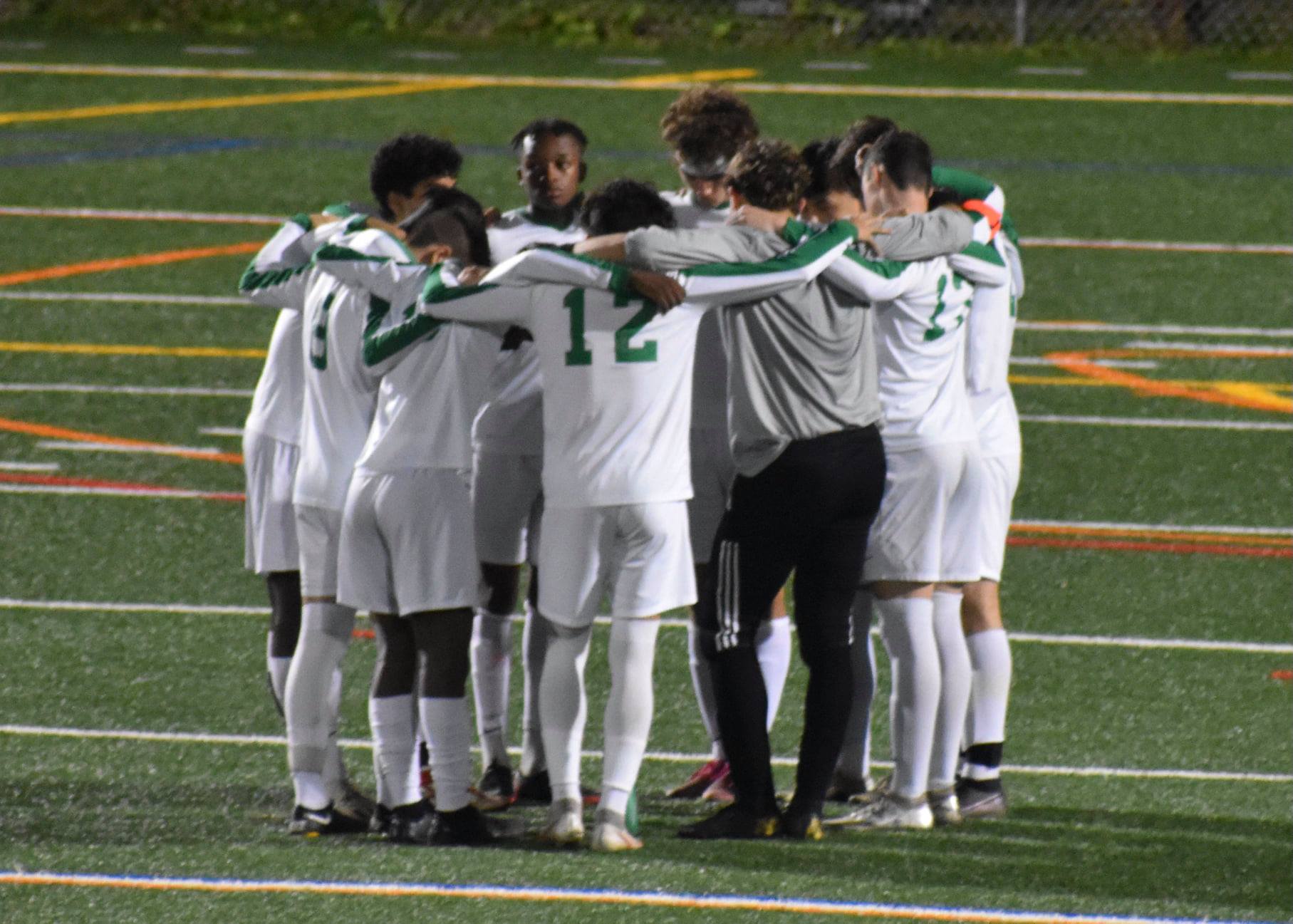 Central boys' soccer team huddle before kickoff